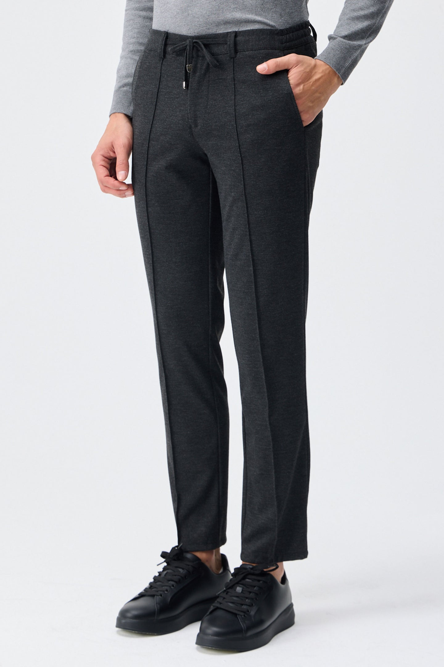 Calça social masculina bege-carvão com cordão e corte afunilado.