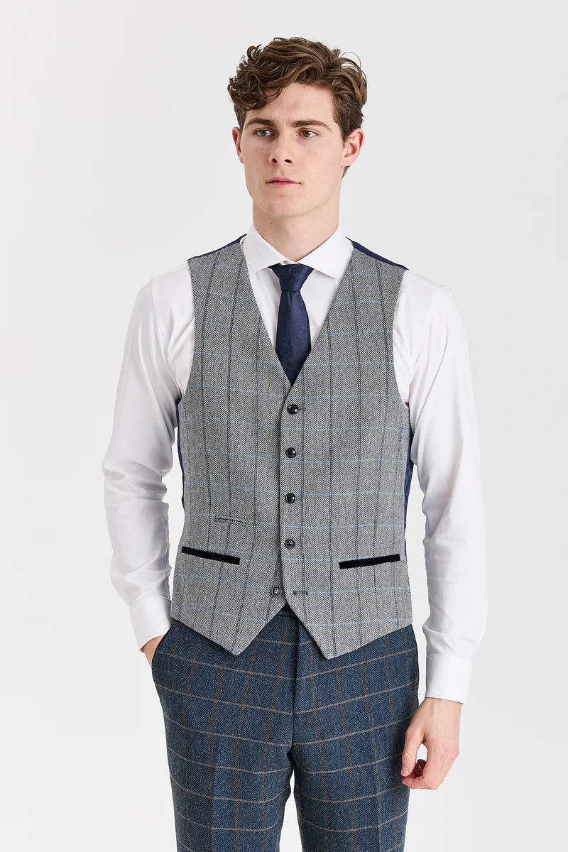 Terno Harris em tweed azul-marinho com colete Harris em tweed cinza contrastante.